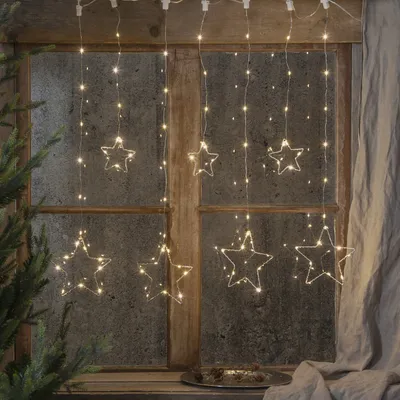Star-shaped string lights hanging in a window.