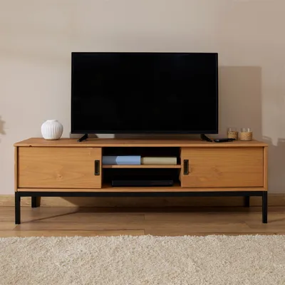 A wooden TV stand with a black metal frame, featuring a television on top and storage compartments below.