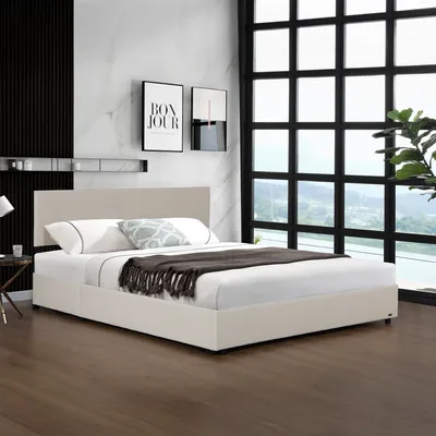 A bedroom scene with a bed, window, and artwork.