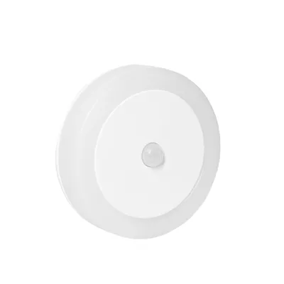 A white, circular LED night light with a motion sensor.