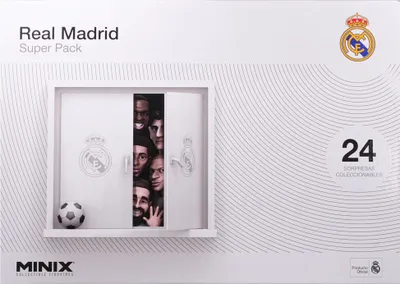 The image shows the front of a Real Madrid Super Pack box, which appears to be an advent calendar. The box has a white background with a subtle wave pattern. A white framed opening reveals several faces of Real Madrid players peeking out. A soccer ball is 
