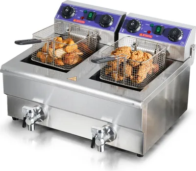 A commercial deep fryer with two baskets filled with fried food.