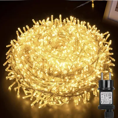 A large coil of warm white LED string lights with a black power adapter in the foreground.