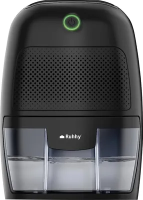 A black dehumidifier with a green power button illuminated.