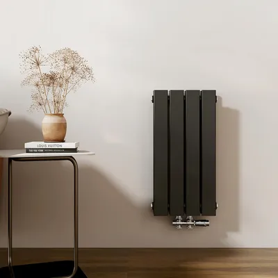 A modern bathroom or living space with a radiator mounted on the wall next to a small side table with decorative items.