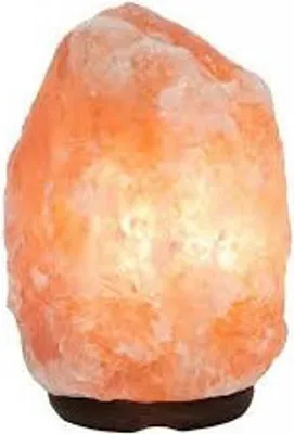 A Himalayan salt lamp on a dark base against a white background.