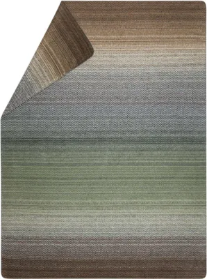 A folded blanket with a gradient color pattern.