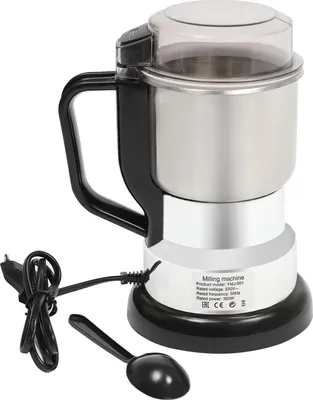 A coffee grinder with its power cord and a scoop.