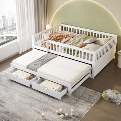 A white wooden daybed with a pull-out trundle bed and storage drawers, set up in a bedroom with a large window and a green curved wall.
