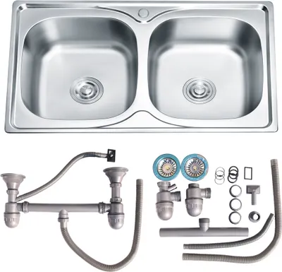A double basin stainless steel kitchen sink and its plumbing accessories are displayed against a white background.