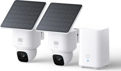 Two white security cameras with solar panels attached, and a white base station.