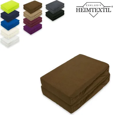 A stack of folded brown fitted sheets is shown in the foreground, with a selection of other colored fitted sheets and a logo in the background.