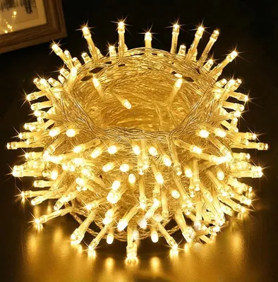 A close-up shot of a tangled ball of warm white LED string lights.