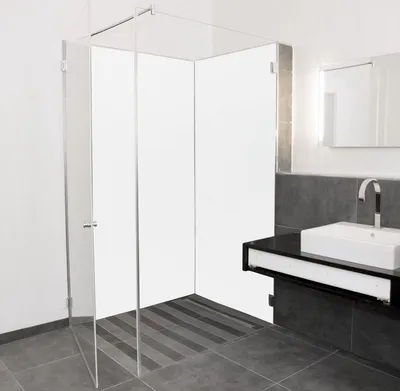 A modern bathroom with a glass shower enclosure and a sink with a faucet.