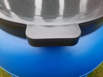 A close-up view of the lid of a blue water barrel.