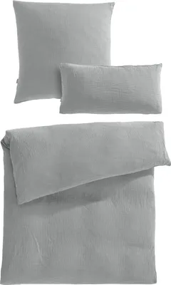 A set of grey bedding items, including a duvet cover and two pillowcases, neatly arranged.