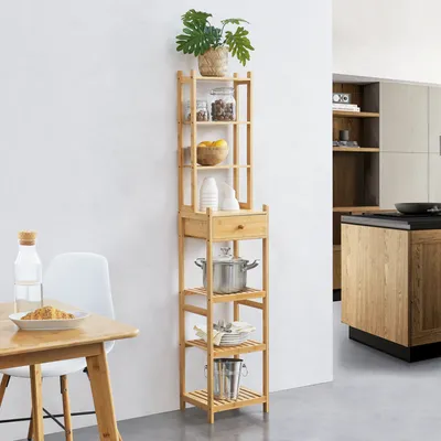 A bamboo shelving unit filled with kitchen items and a plant, placed in a modern kitchen setting.