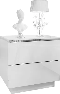 A white, glossy nightstand with two drawers, topped with a bust and a decorative lamp.