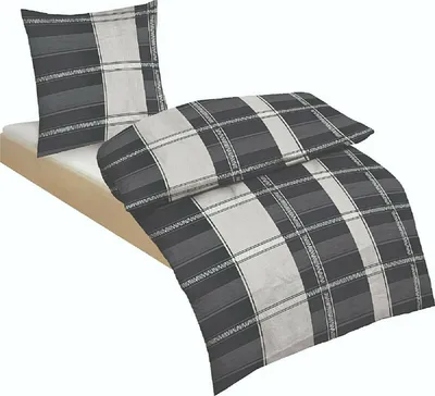 A bedding set on a bed frame.