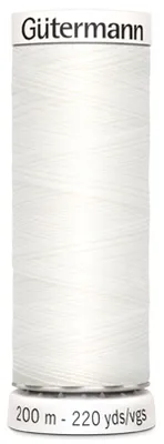 A spool of white thread on a white background.
