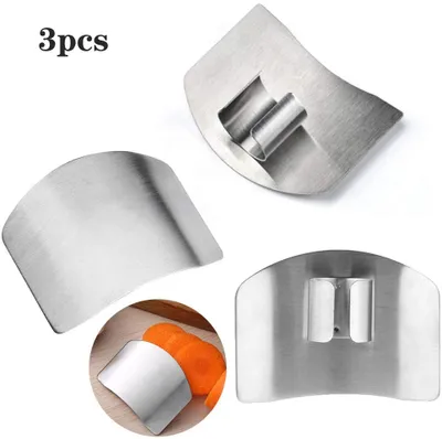 Three stainless steel finger guards for kitchen use, with one guard shown protecting a finger while slicing carrots.