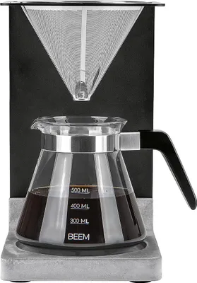 A pour-over coffee maker set with a glass carafe filled with coffee.