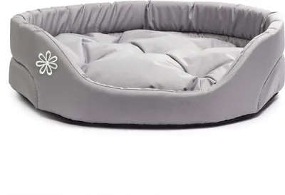 A gray oval dog bed with a white flower logo on the side, shown on a white background.