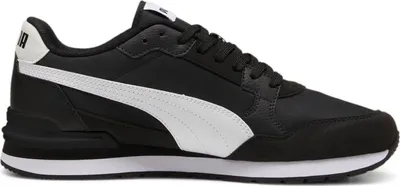 A studio shot of a black Puma sneaker with a white stripe.