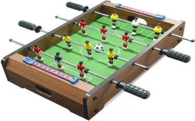 A miniature foosball table with players in red and yellow uniforms.