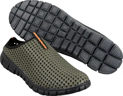 A pair of green slip-on shoes with a perforated design and black soles, shown from a diagonal angle with one shoe placed on top of the other, revealing the sole of the top shoe.
