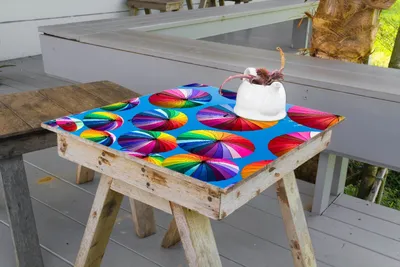 Produktbild von Wallario selbstklebende Möbelfolie/ Tischdecke für Innen und Außen, Größe: 70 x 70 cm - Bunte Regenschirme vor blauem Himmel
