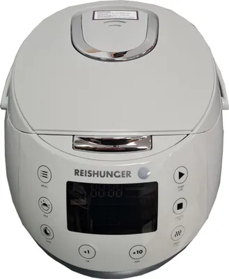 A white rice cooker is shown from the front.