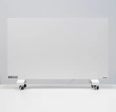 A white electric heater with wheels is shown in a studio setting against a light gray wall.