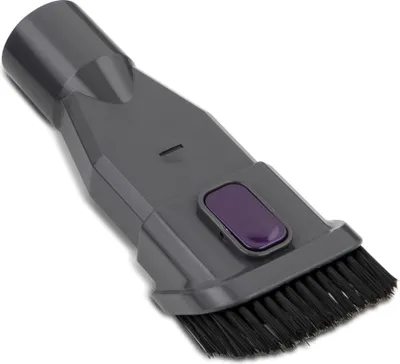 A close-up studio shot of a gray vacuum cleaner attachment with a purple button and black bristles.