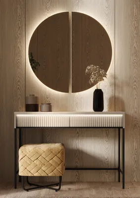 A modern vanity table with a round mirror and a stool in a bedroom setting.