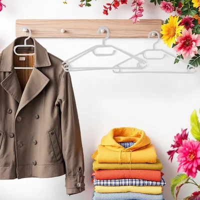 A jacket on a hanger and a stack of folded clothes on a wooden shelf.