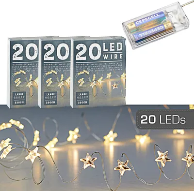 Three boxes of LED wire lights and a battery pack with batteries, with a string of lights in the foreground.