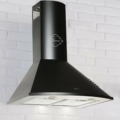 A black kitchen range hood mounted on a white brick wall.
