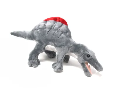 A plush toy dinosaur with a red sail on its back, shown against a white background.