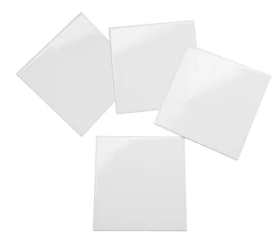 Four white square tiles are arranged in a scattered pattern on a white background.
