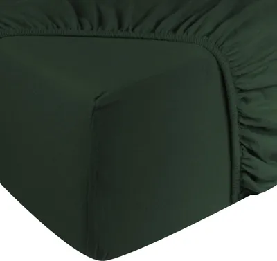 A close-up view of a dark green fitted sheet, showing the elasticized corner.