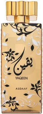 A bottle of perfume with ornate gold, black, and white floral patterns.