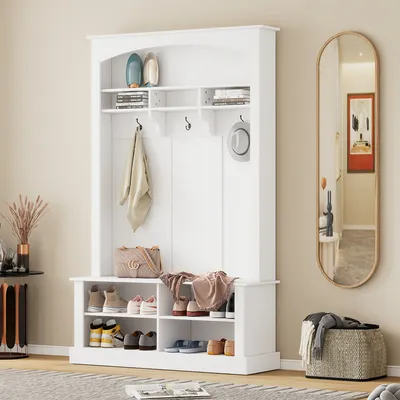 A white hall tree with a bench and shoe storage is shown in a room with a mirror and basket.