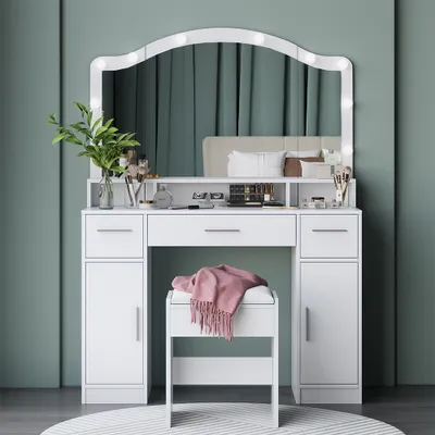 A white vanity table with a large LED mirror and a stool in front of it, set against a green backdrop.