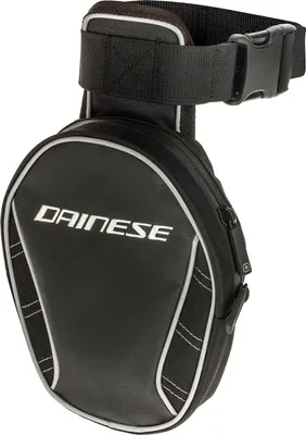 A black Dainese leg bag with silver trim and a black strap with a buckle.