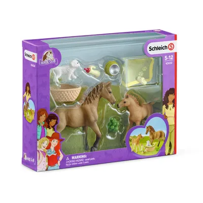 A toy playset featuring horses, a dog, and accessories, presented in its retail packaging.
