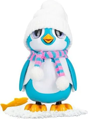 A toy penguin dressed in a hat and scarf, standing on a snowy surface next to a fish.