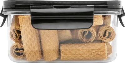 A clear, well-lit studio shot of a food storage container filled with wafer rolls.