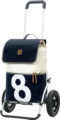 A shopping trolley with a navy blue and cream bag, featuring a large white number '8'.