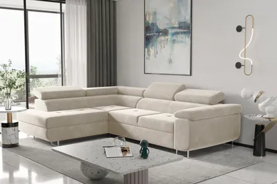 A modern living room with a large sectional sofa, coffee table, and artwork.